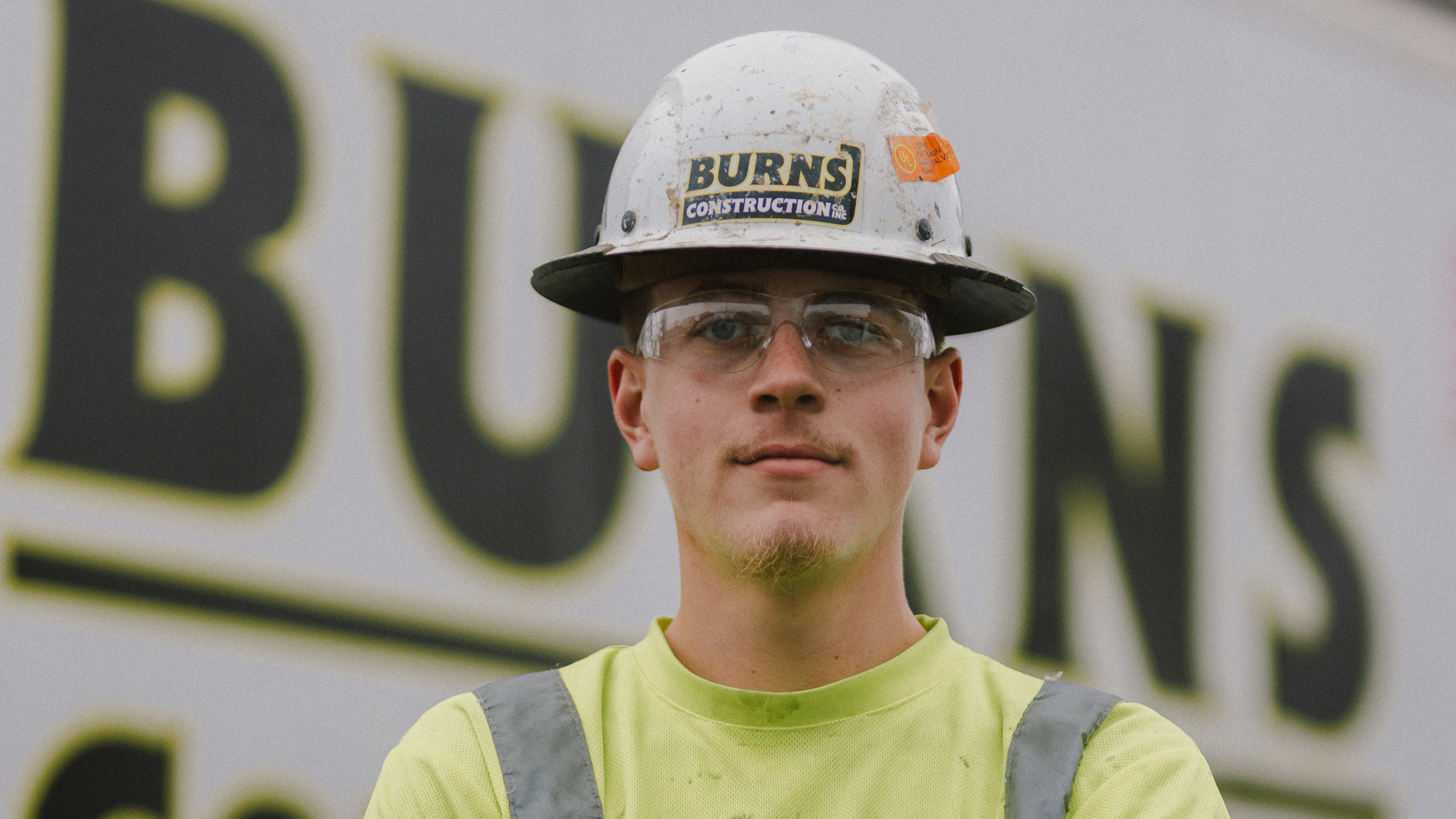 Burns Construction crew compacting underground utility trench